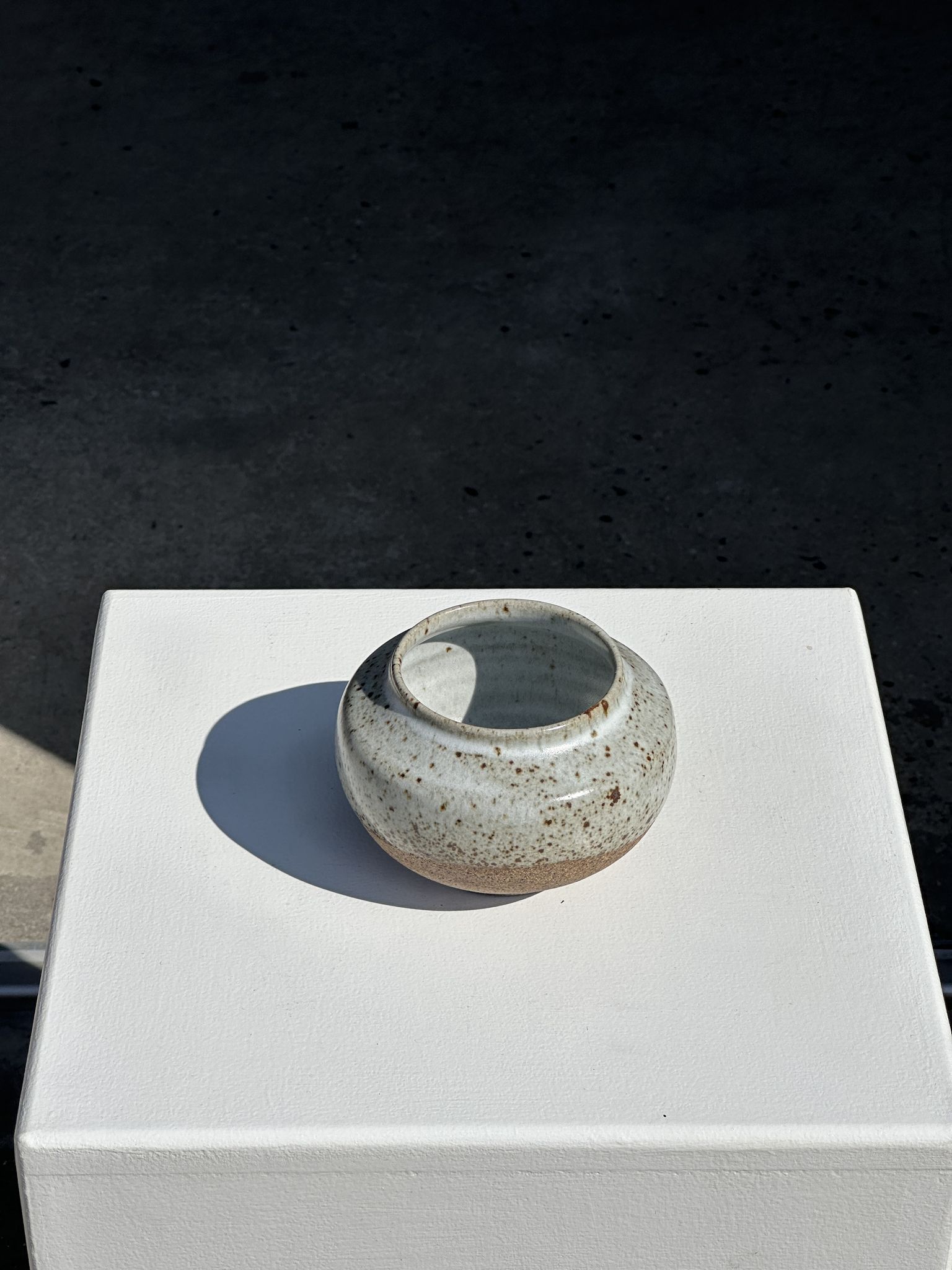 Small white ball vase tight neck in glazed speckled ceramic