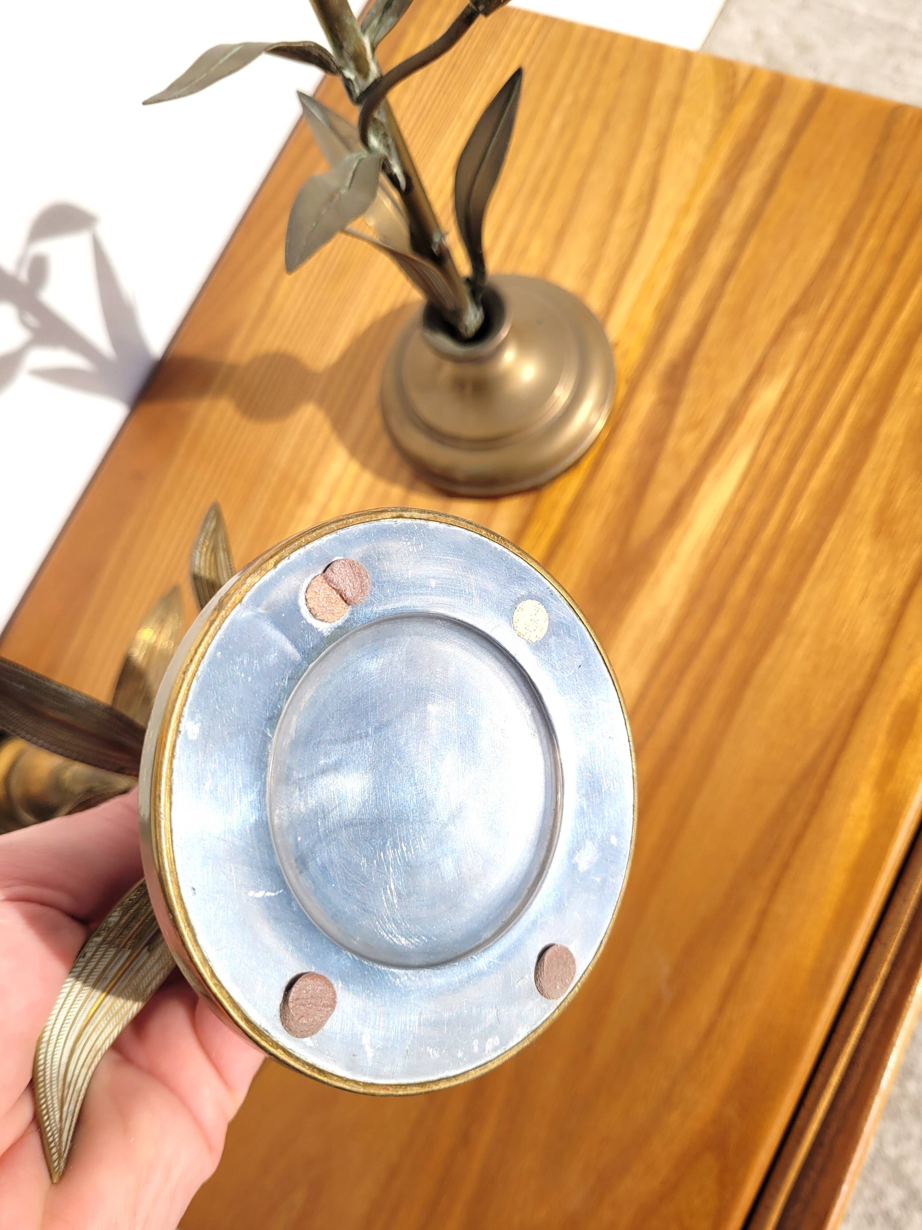 Pair of brass candlesticks with plant decoration