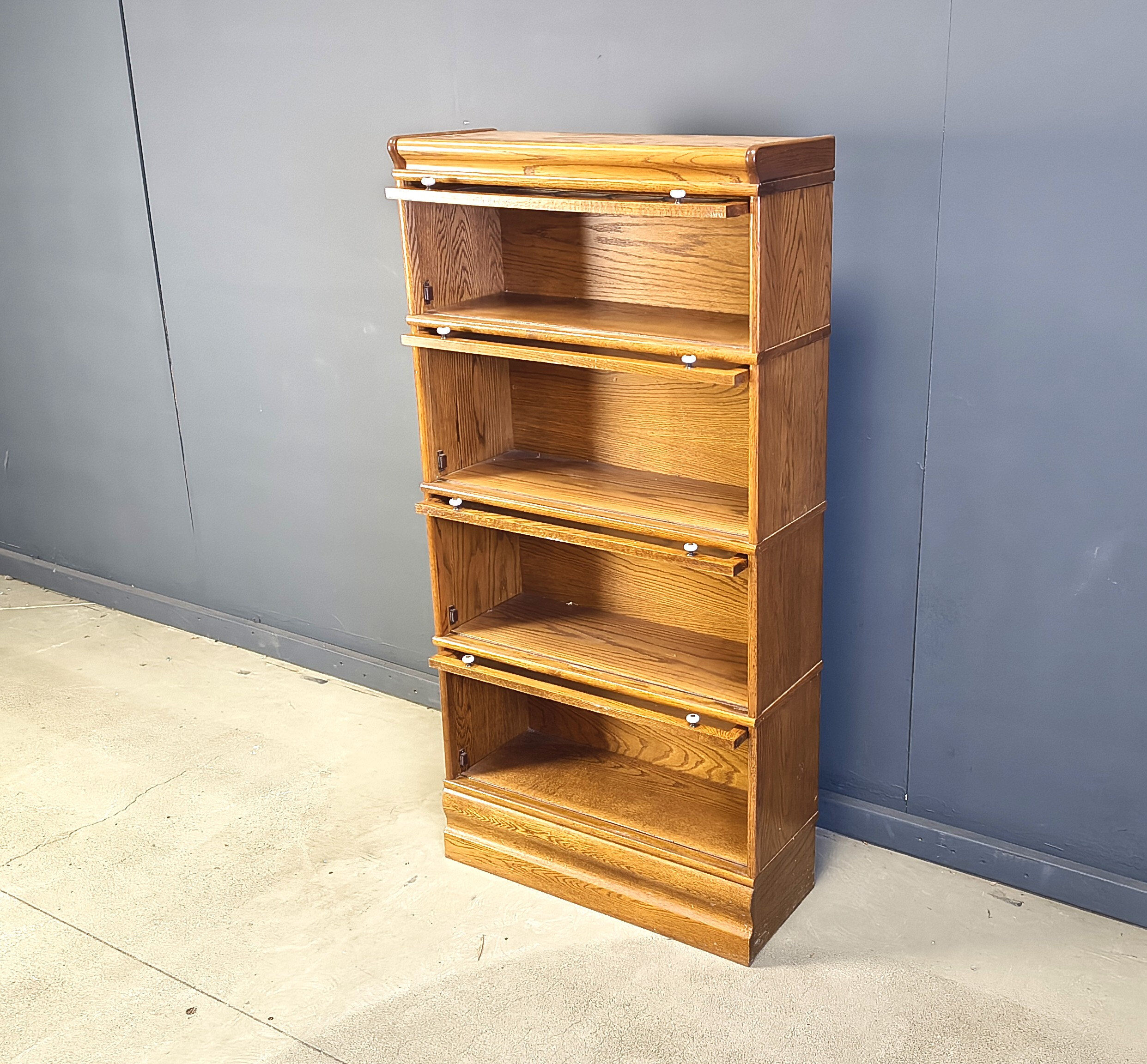 Four tier oak barrister style bookcase with leaded glass