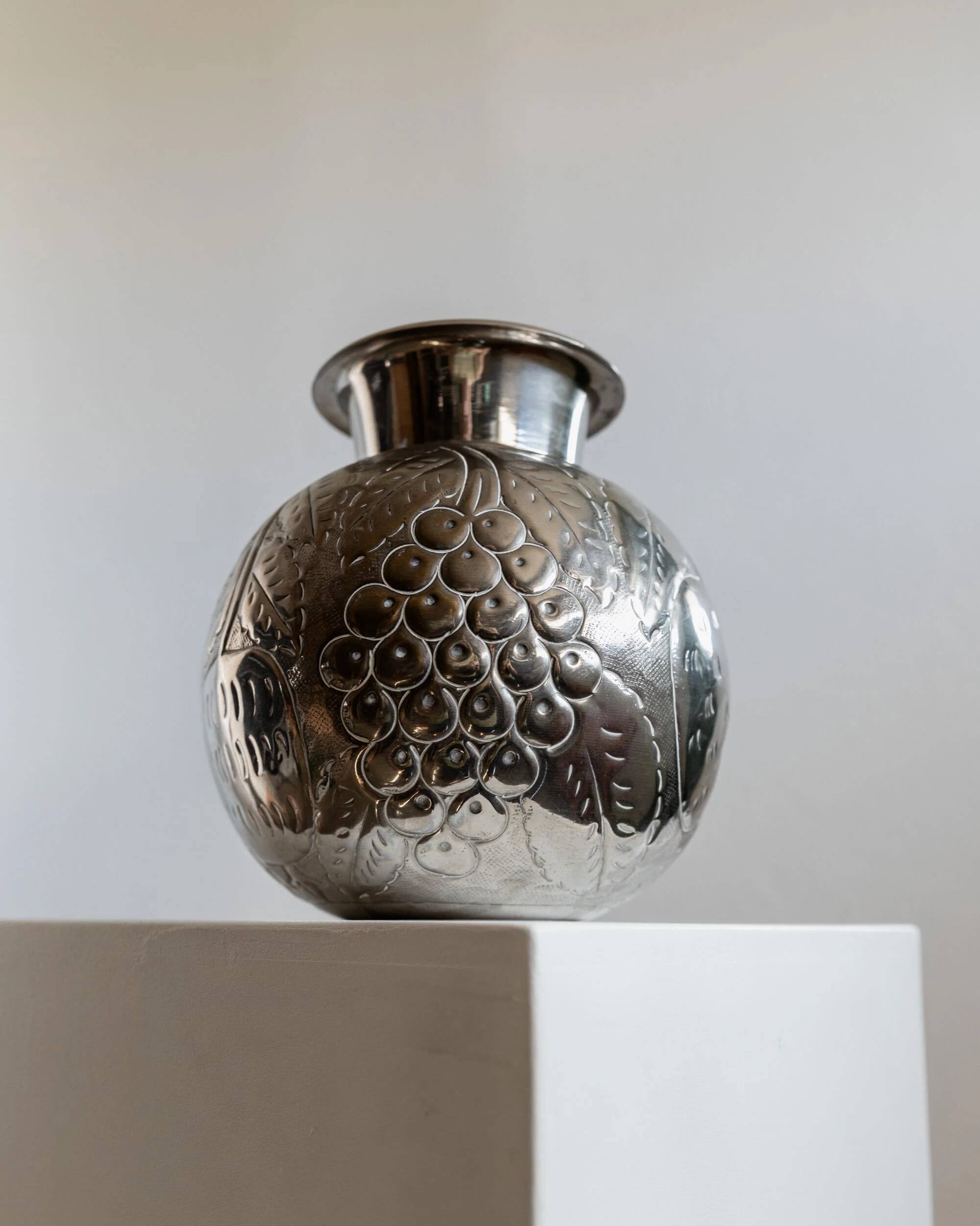 Vintage Italian vase in nickel-plated brass from the 1960s, hand-hammered relief of fruits and leaves.