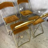Four folding velvet and brass chairs