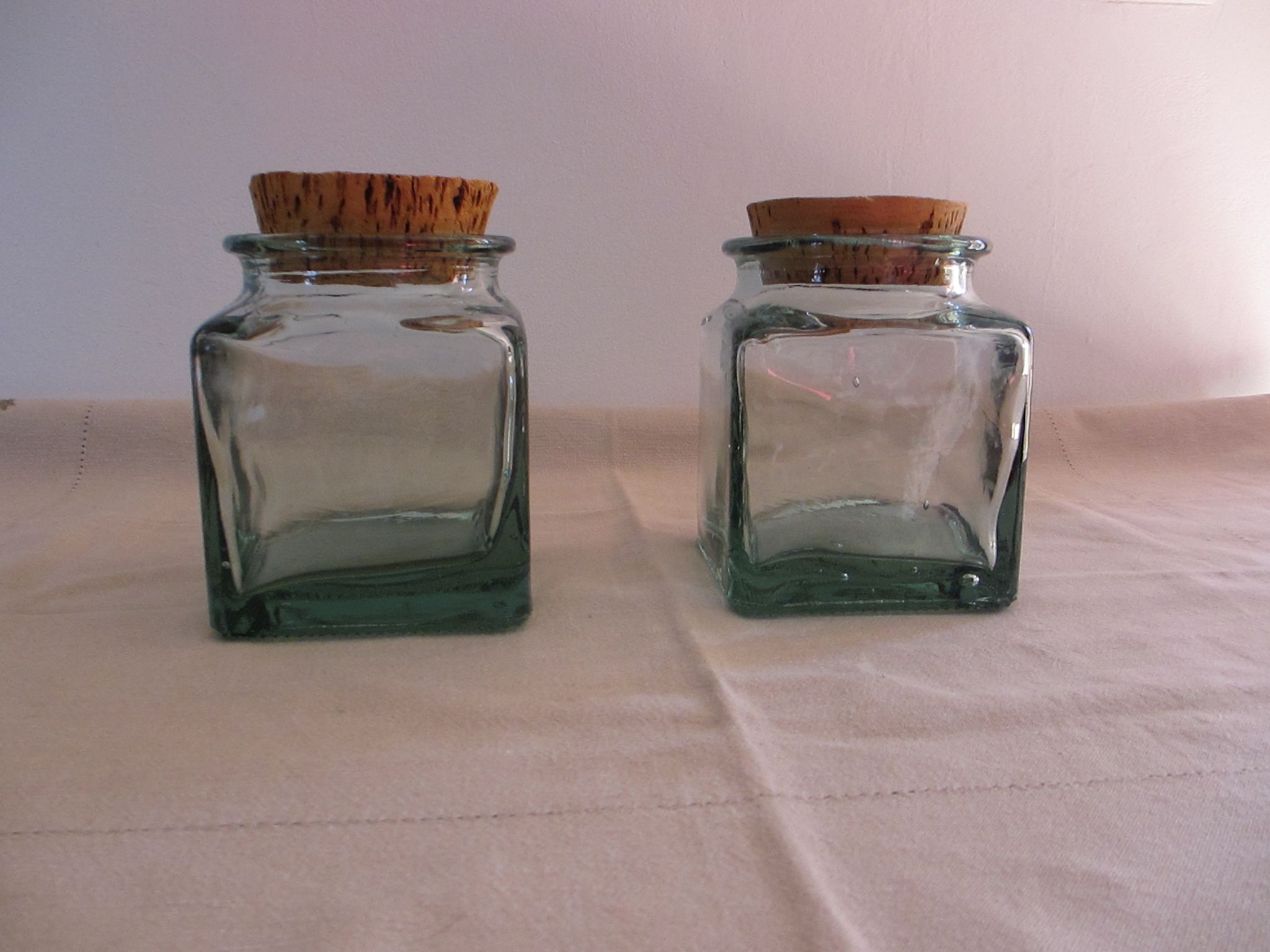 2 glass jars with crusted cork stopper