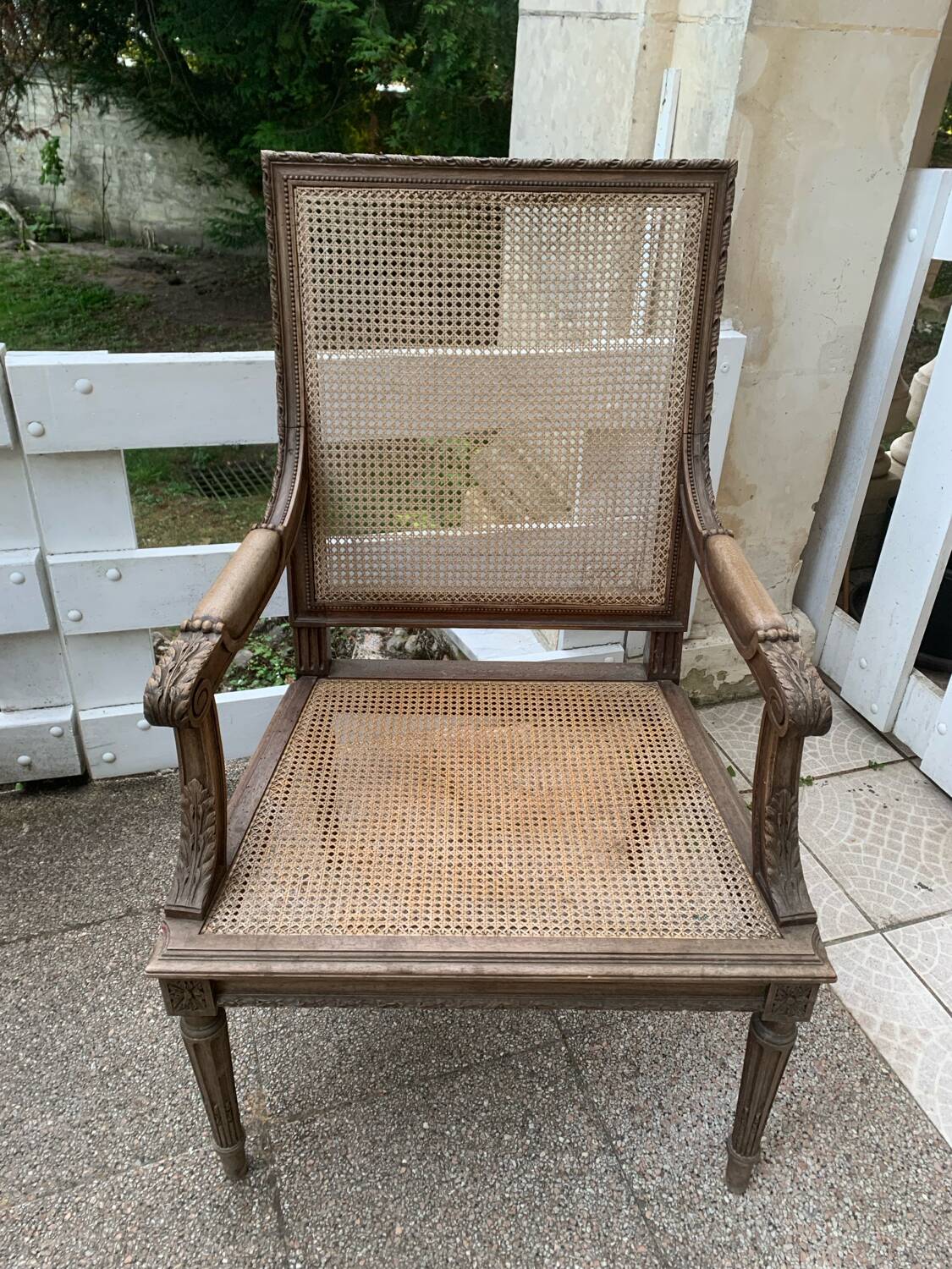 Wooden armchair with caning in Louis XVI style