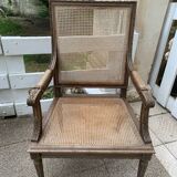 Wooden armchair with caning in Louis XVI style