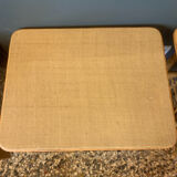 A pair of rattan bedside tables.