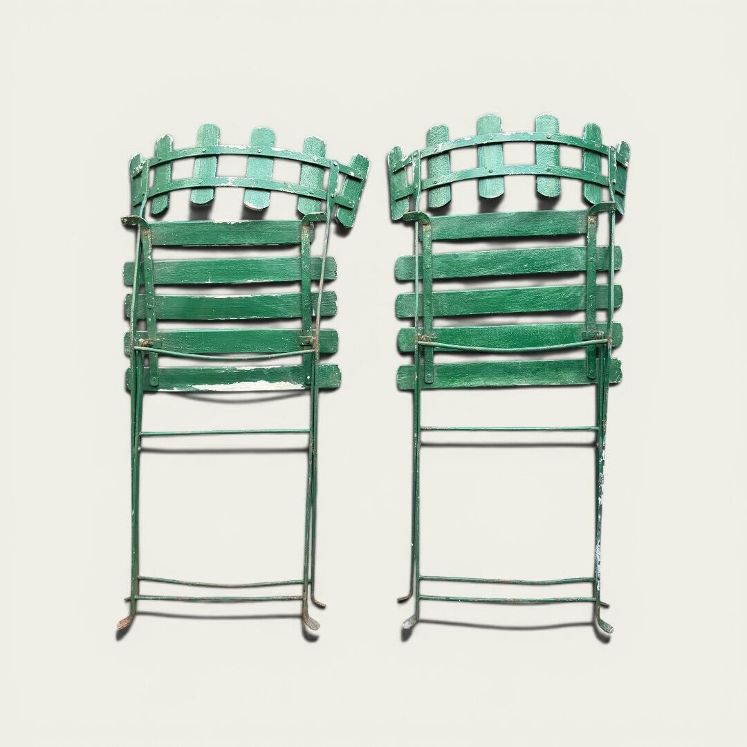 Pair of original patinated folding Parisian bistro chairs.