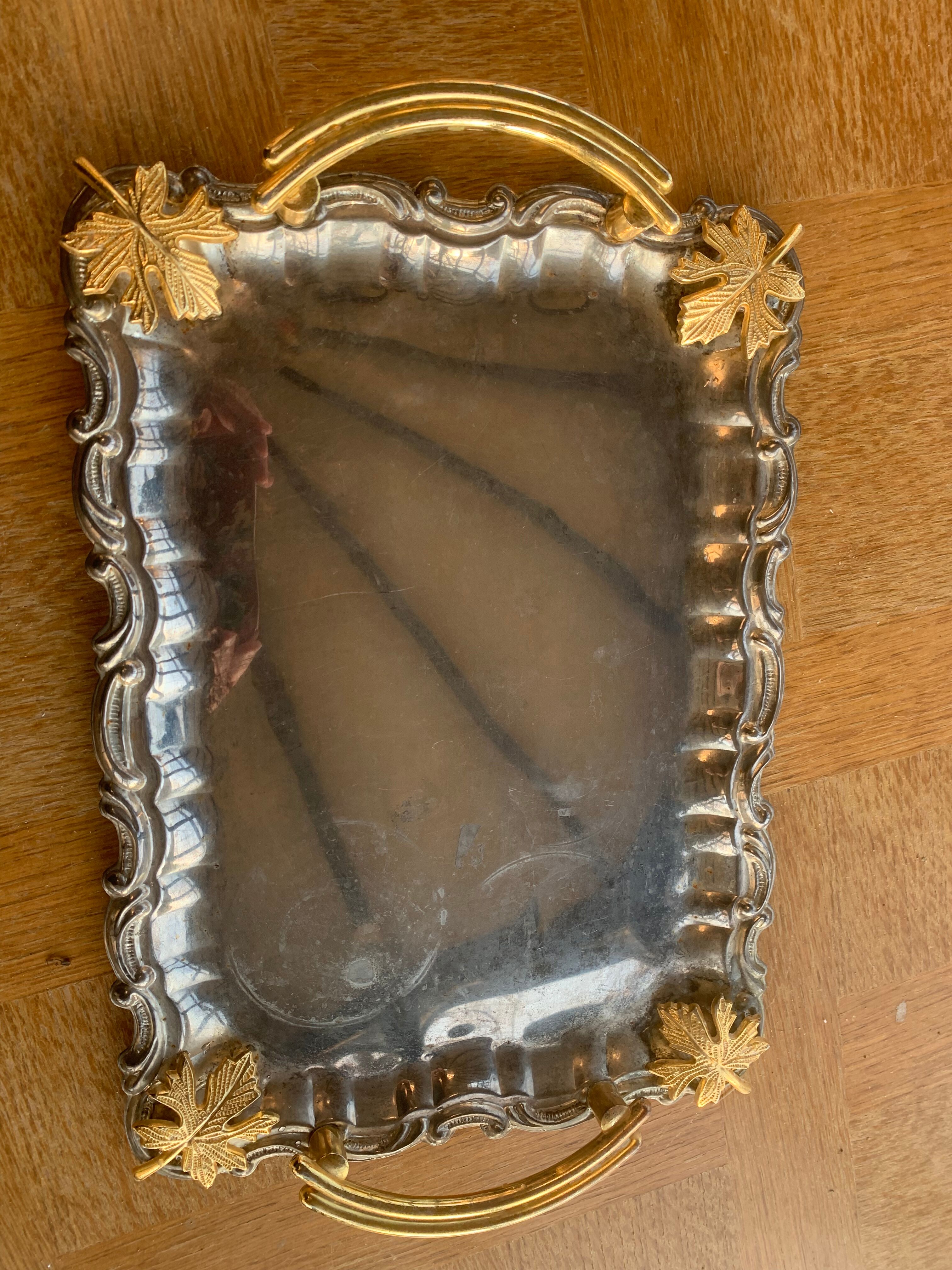 Silver metal top and decoration of foliage and handles in vintage brass