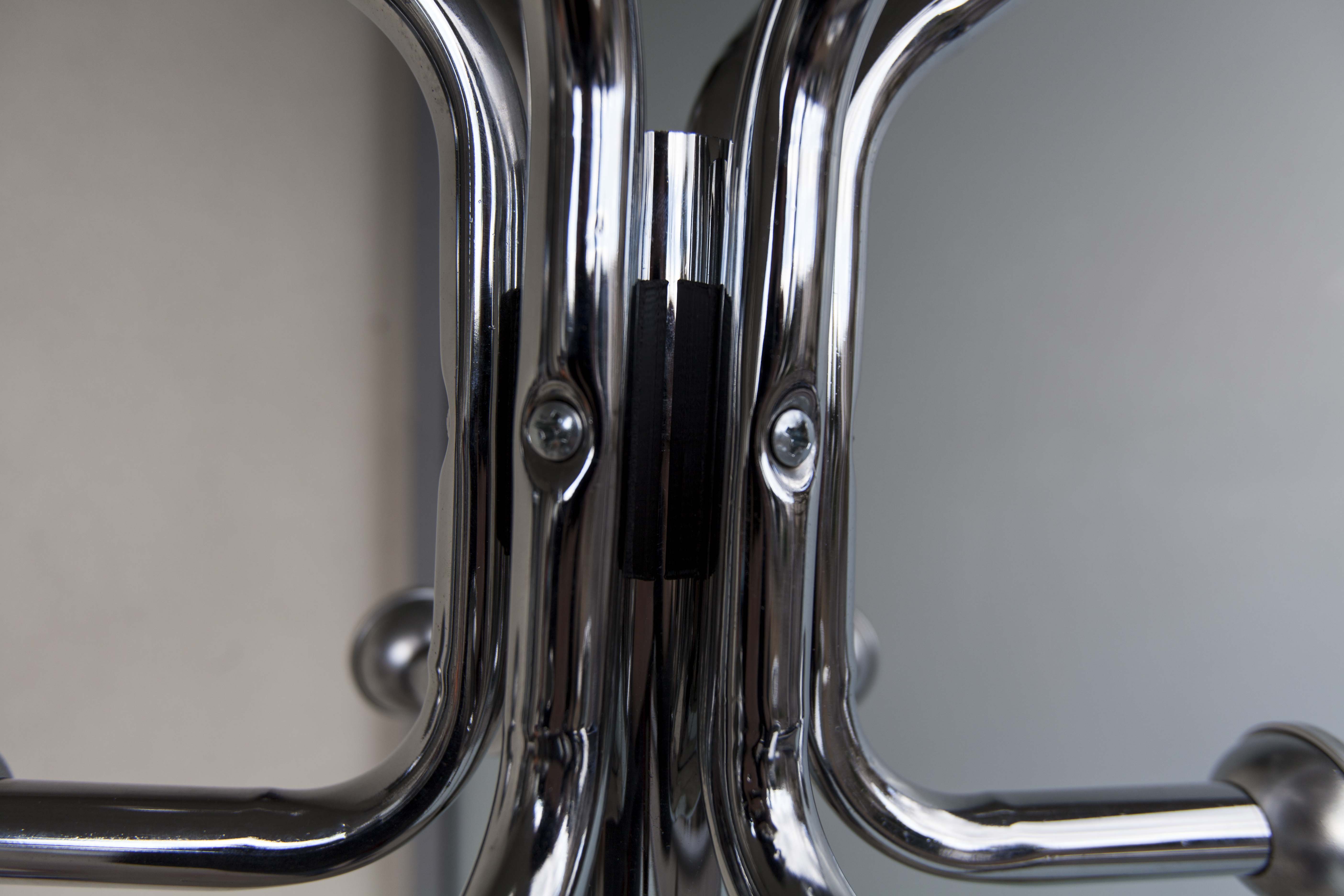 Chrome metal parrot coat holder from the 70s