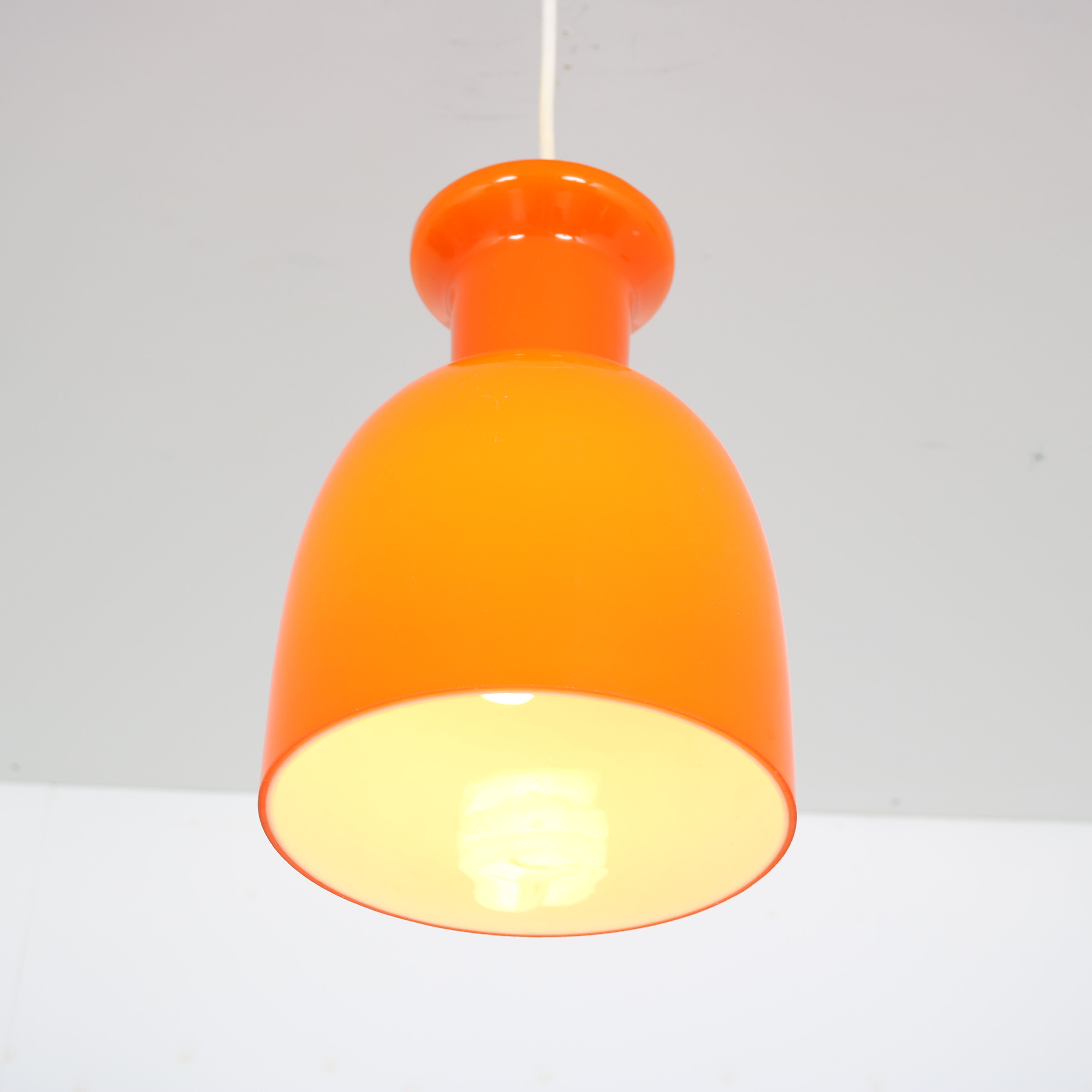 Pair of orange hanging lamps by Raak, the Netherlands, 1970