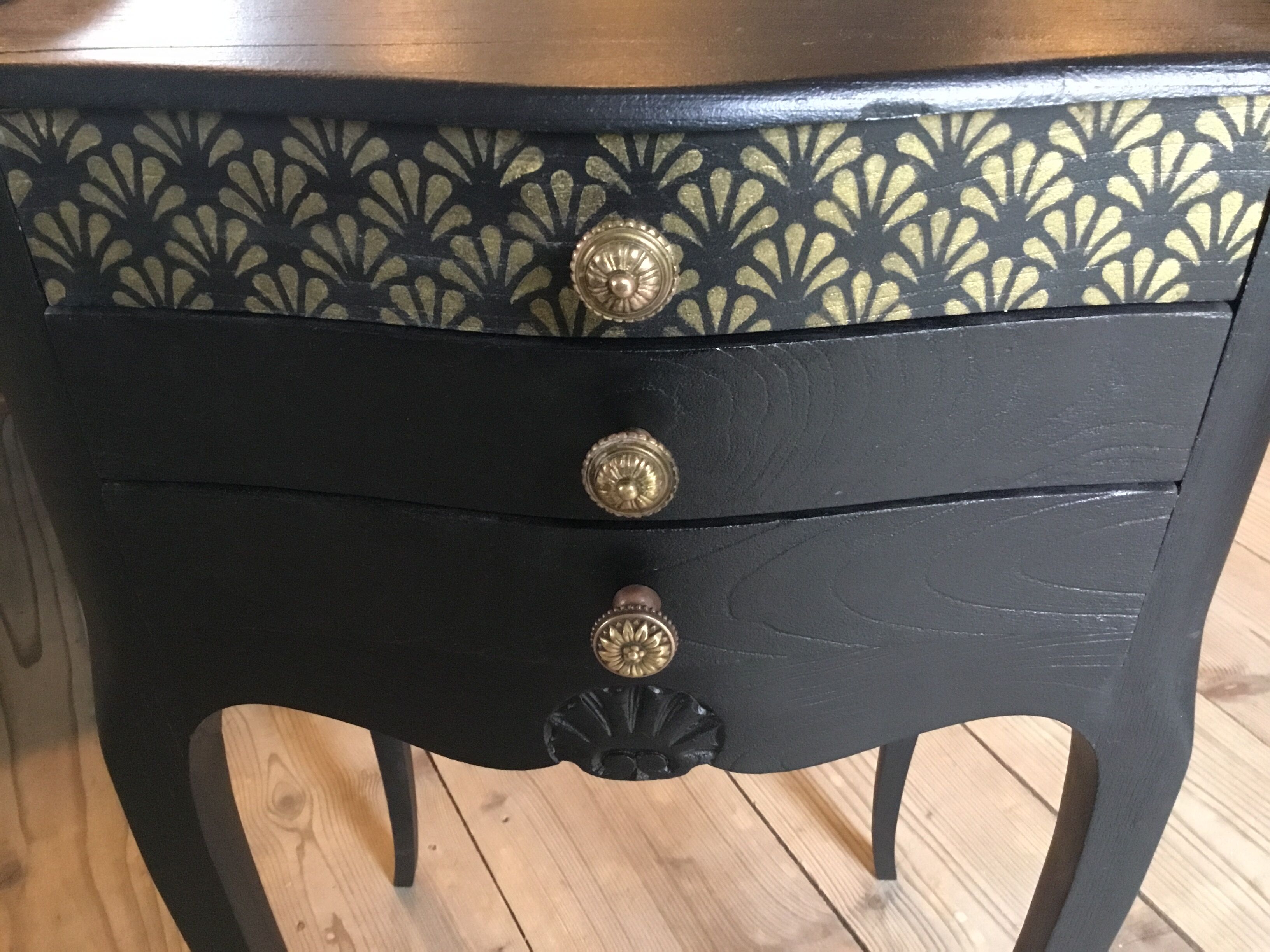 Bedside or nightstand painted black with patterns