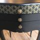 Bedside or nightstand painted black with patterns