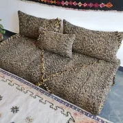 Moroccan sofa on the floor – black and gold pattern