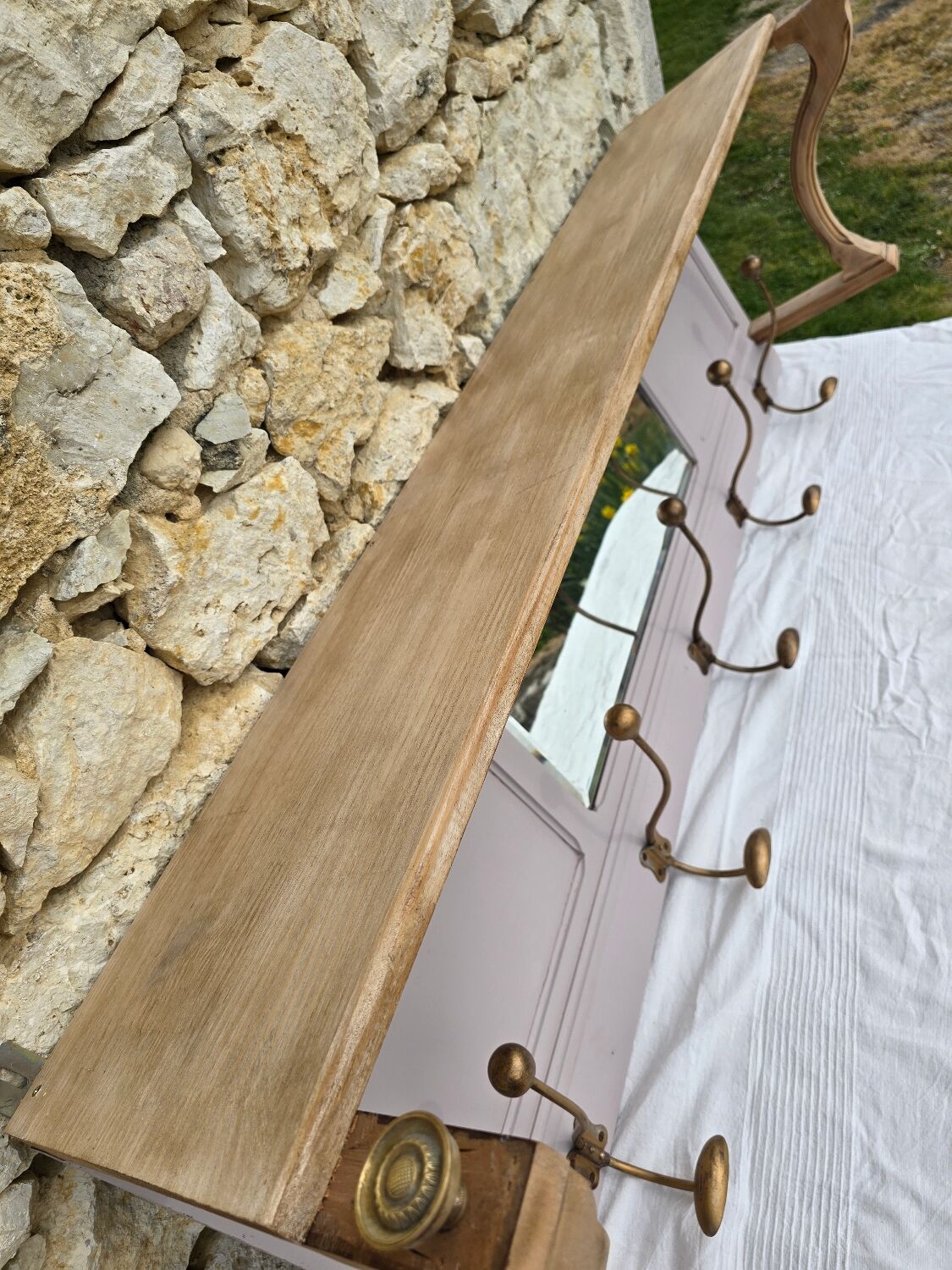 Coat rack or wall-mounted entrance wardrobe with scroll arms and antique hooks.