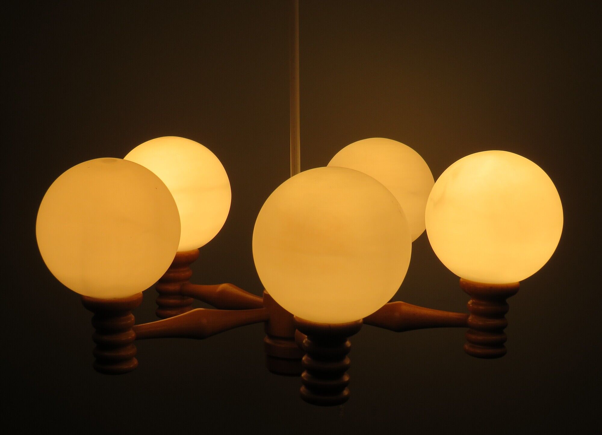 Space age chandelier in 5-arm wood with white frosted opaline glass spheres.