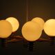 Space age chandelier in 5-arm wood with white frosted opaline glass spheres.