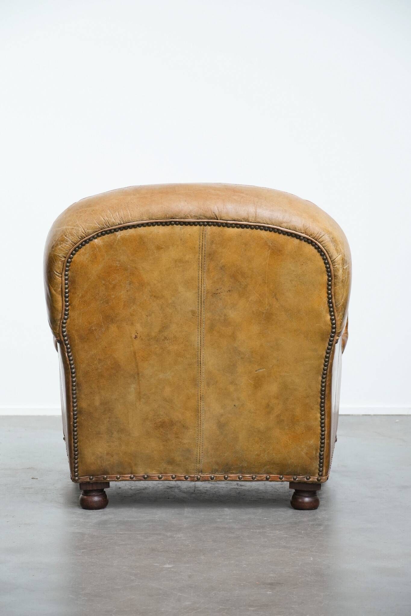 Charming and comfortable vintage armchair in grained cowhide leather with character