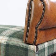 Antique daybed reupholstered with sheepskin and Scottish tartan wool