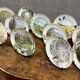 Peter Banett: collection of 12 painted porcelain wall plates