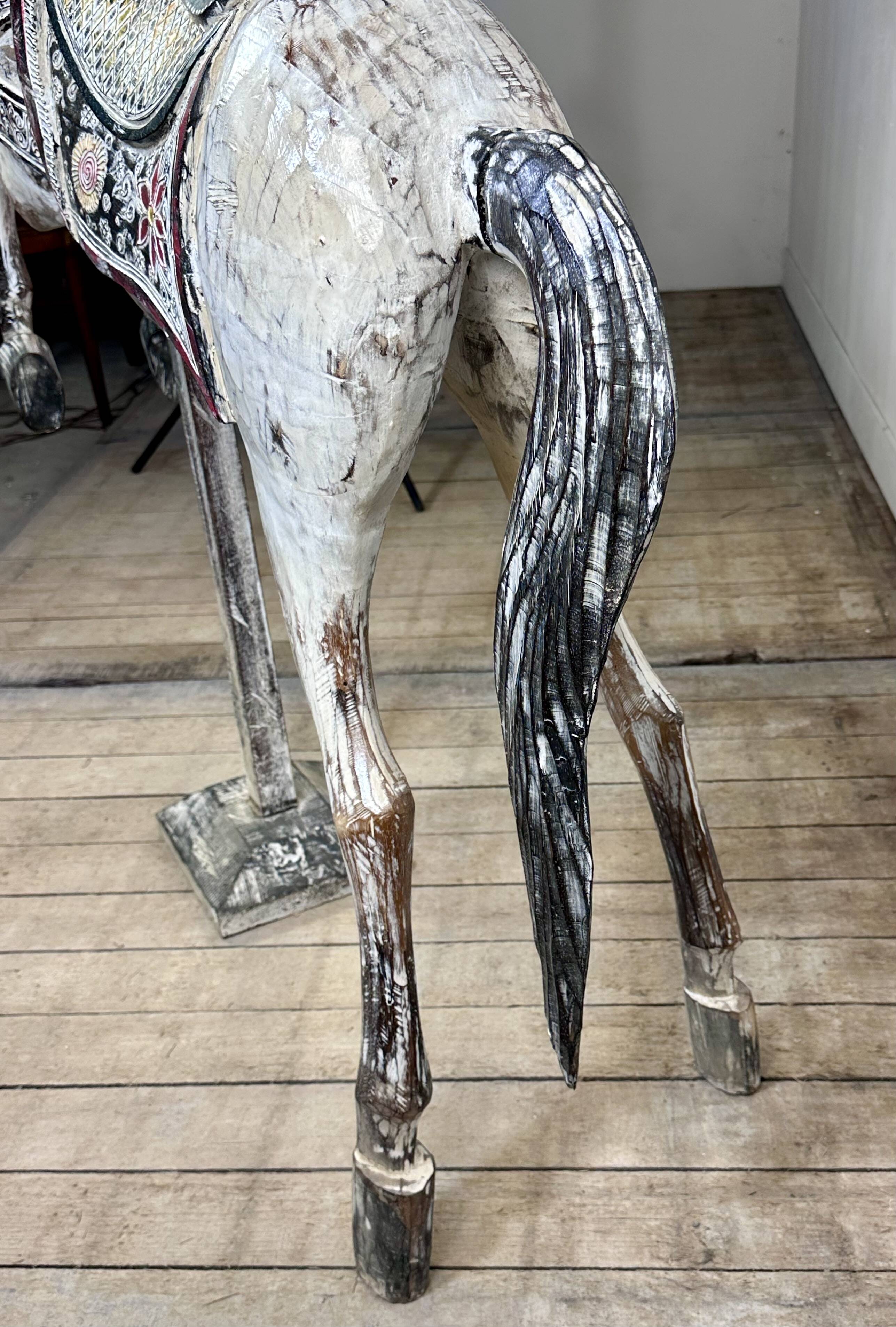 Carved and patinated wooden carousel horse