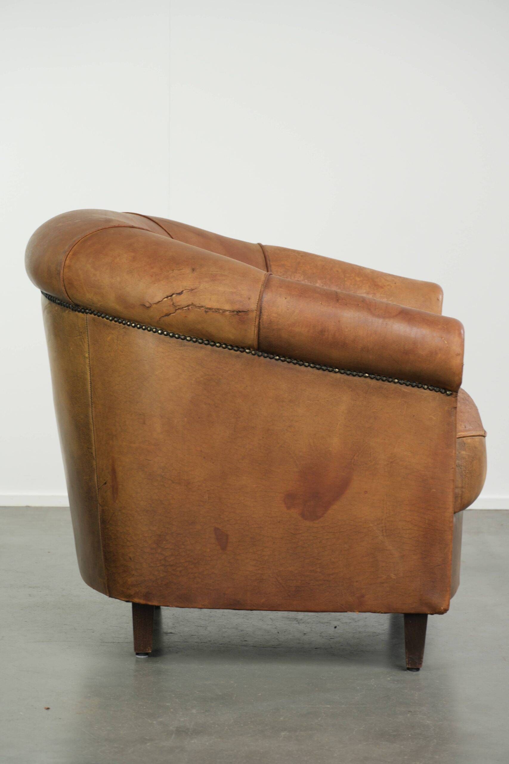 Aged sheepskin clubchair with beautiful vintage patina and comfortable seat