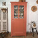 Antique glass-fronted terracotta cupboard