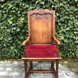 Wooden armchair with velvety red cushion