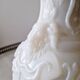 White opaline vase decorated with arabesques and ram's heads