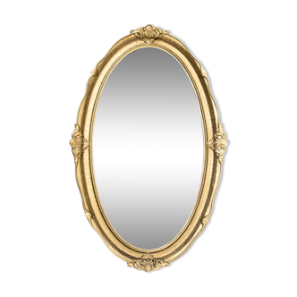 Oval mirror in a golden frame