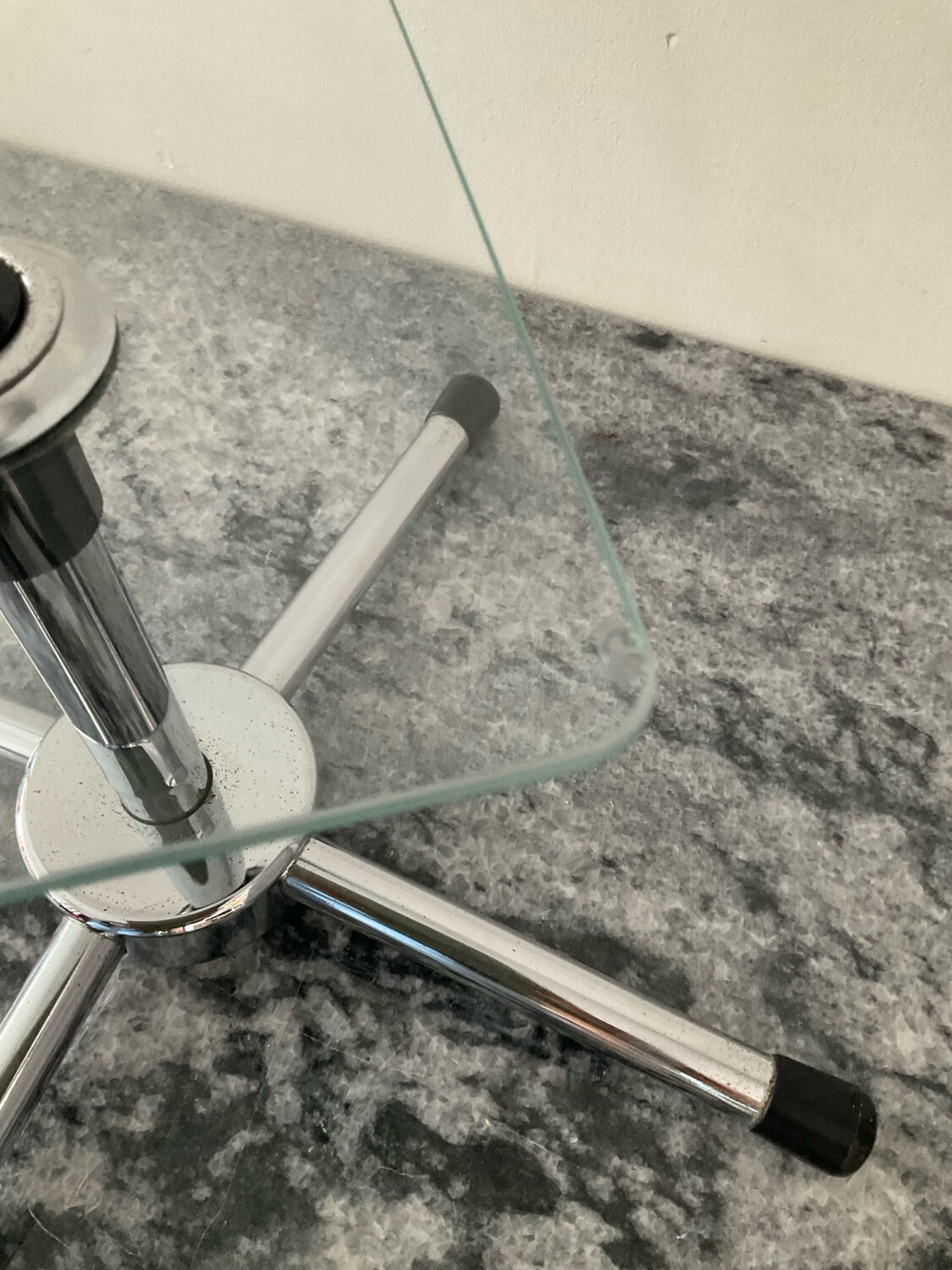 A pair of vintage side tables in glass and chrome metal.