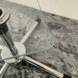 A pair of vintage side tables in glass and chrome metal.