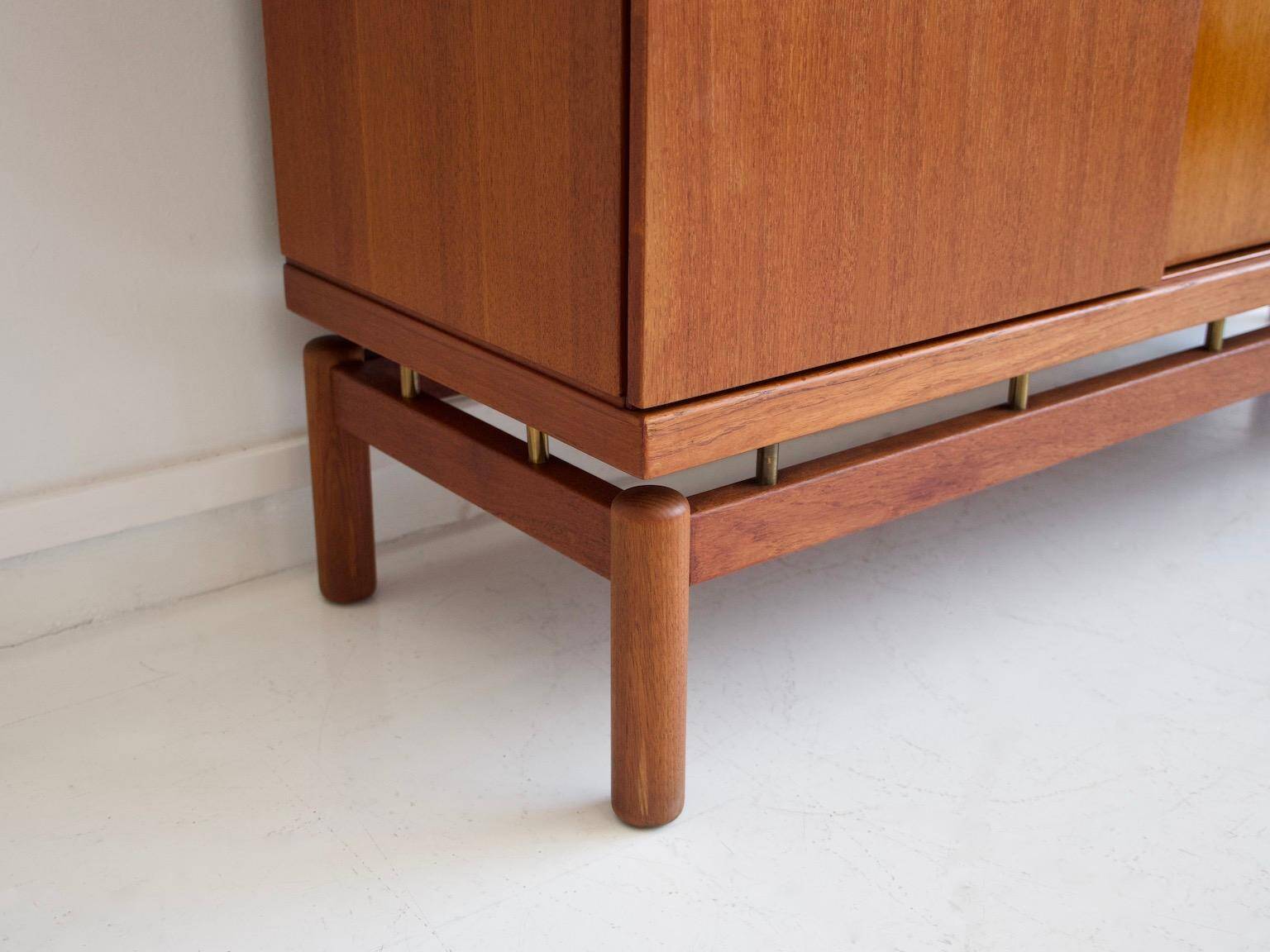 Modern mid-century teak sideboard with brass details.