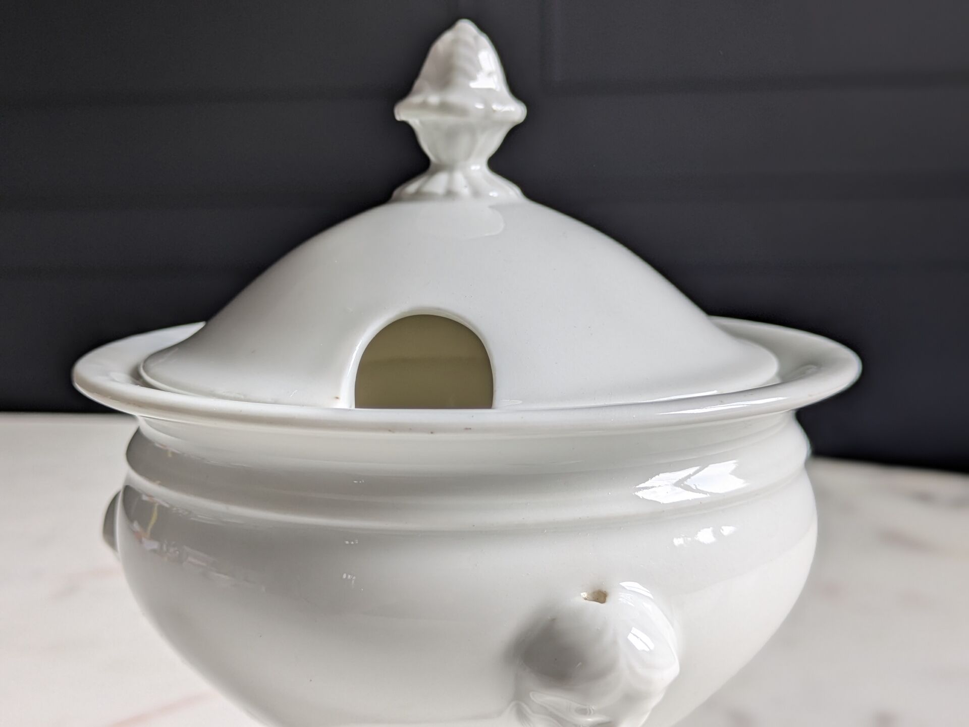 White porcelain confiturier with lion paws and masks. 19th century.
