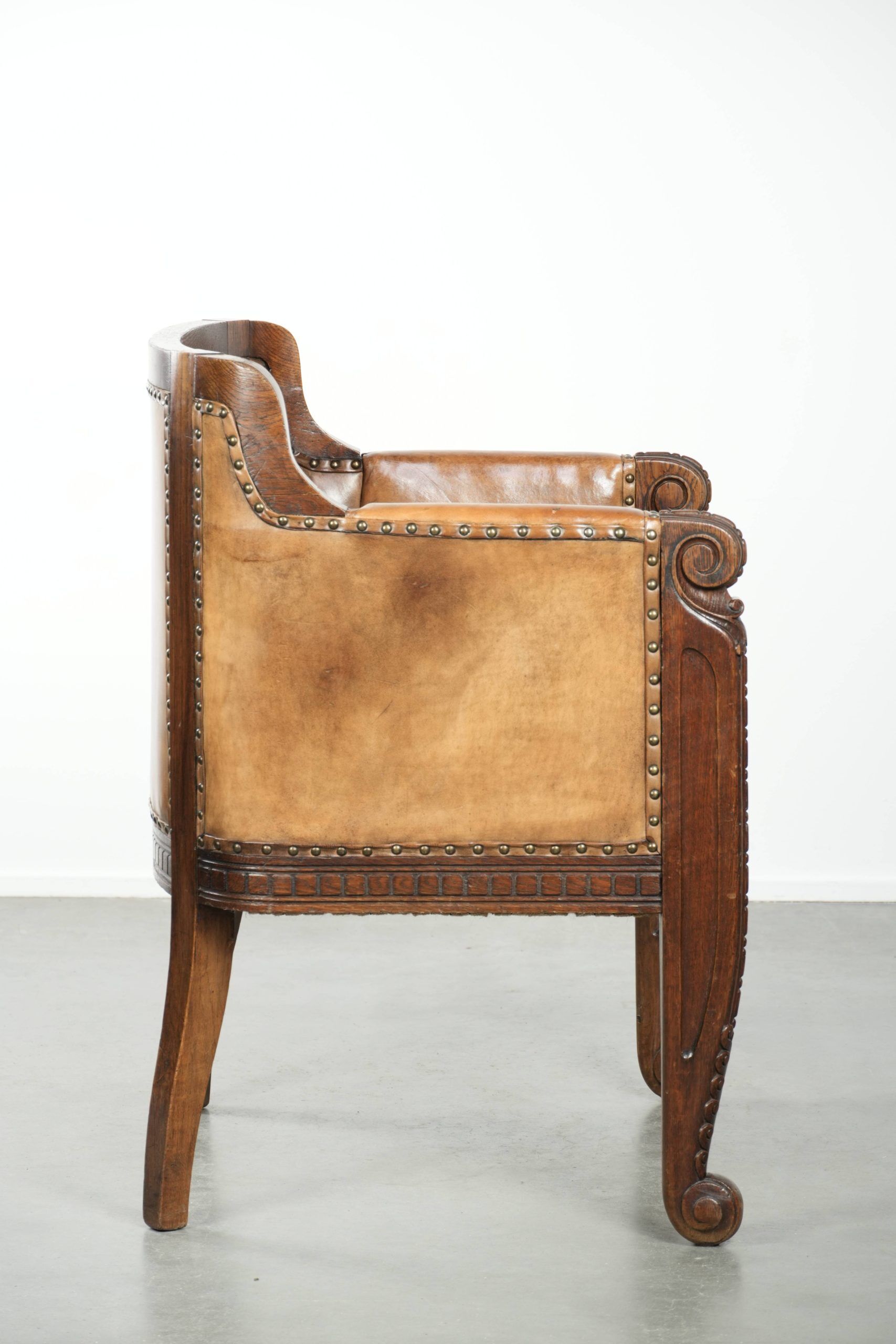 Antique armchair made of sheepskin and wood with decorative nails