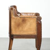 Antique armchair made of sheepskin and wood with decorative nails