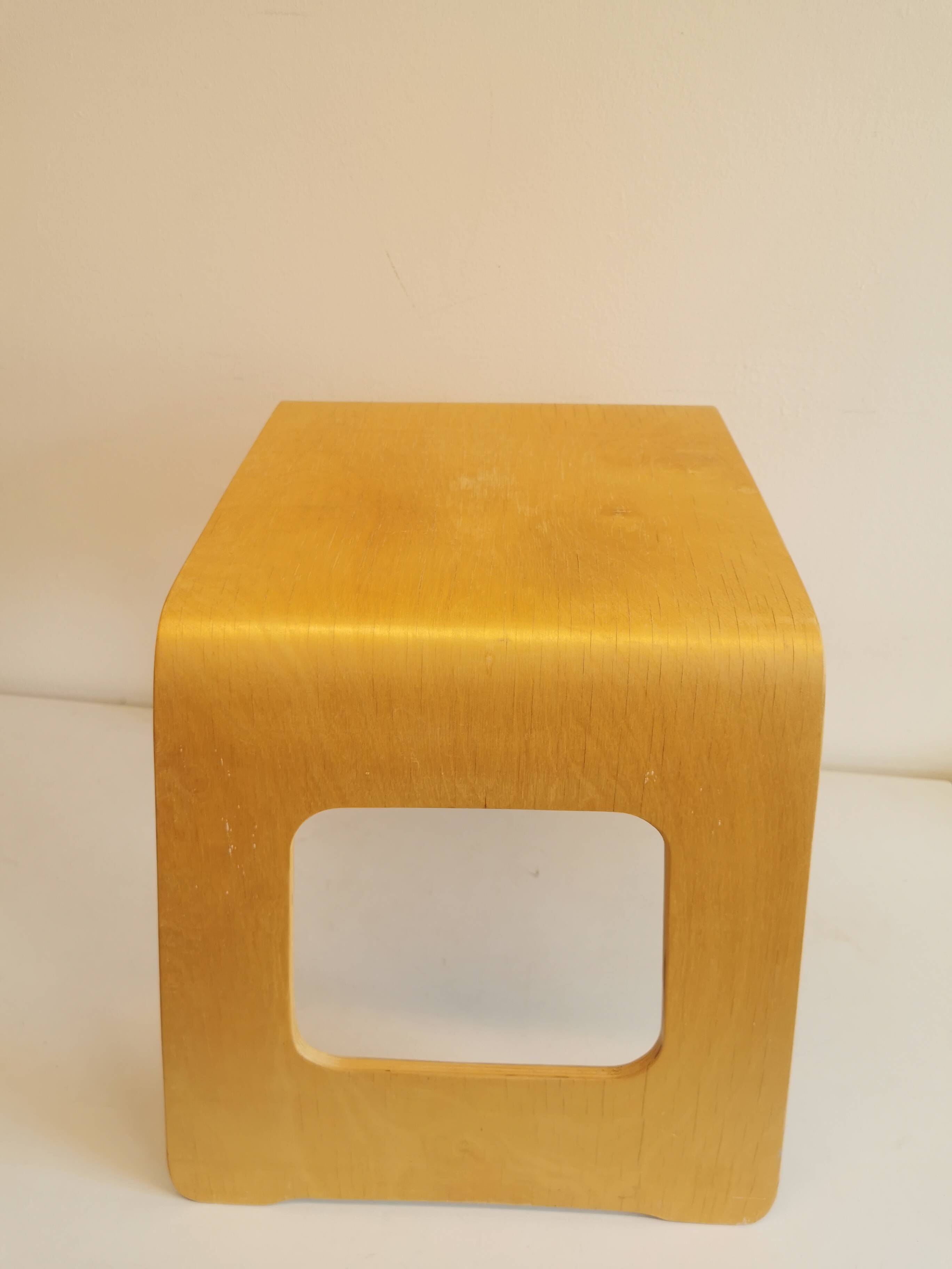 Design stool/side table made of curved plywood.