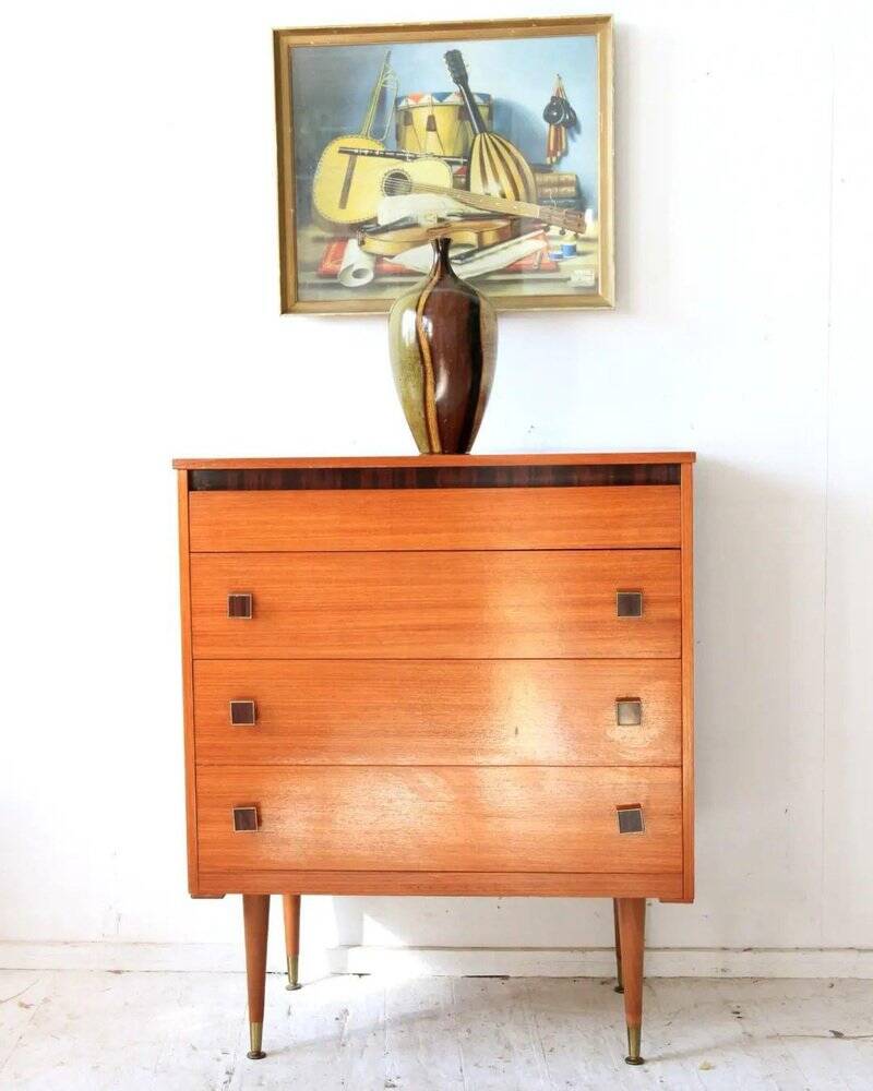 Mid-century brown teak chest of drawers with three drawers, tapered legs from the 1960s.