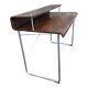 Design desk in formed glued laminated wood with chrome tubular base.