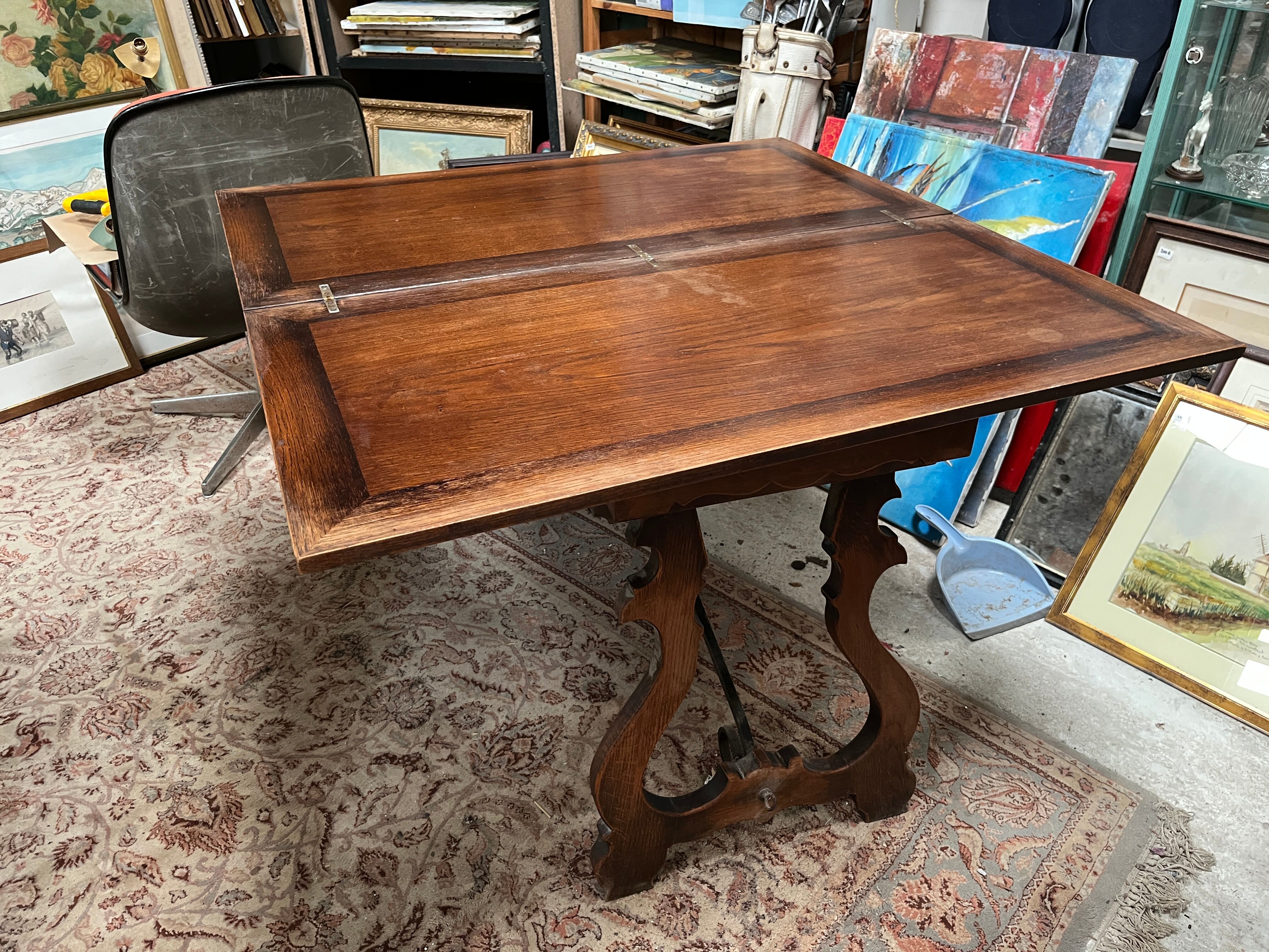 Spanish style table in carved wood and wrought iron