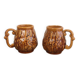 Set of 2 vintage caramel-colored slip mugs with flower pattern