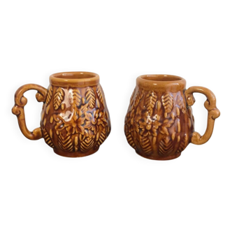 Set of 2 vintage caramel-colored slip mugs with flower pattern