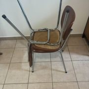 Two brown faux leather chairs.