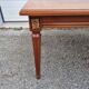 English wood coffee table with leather shelves