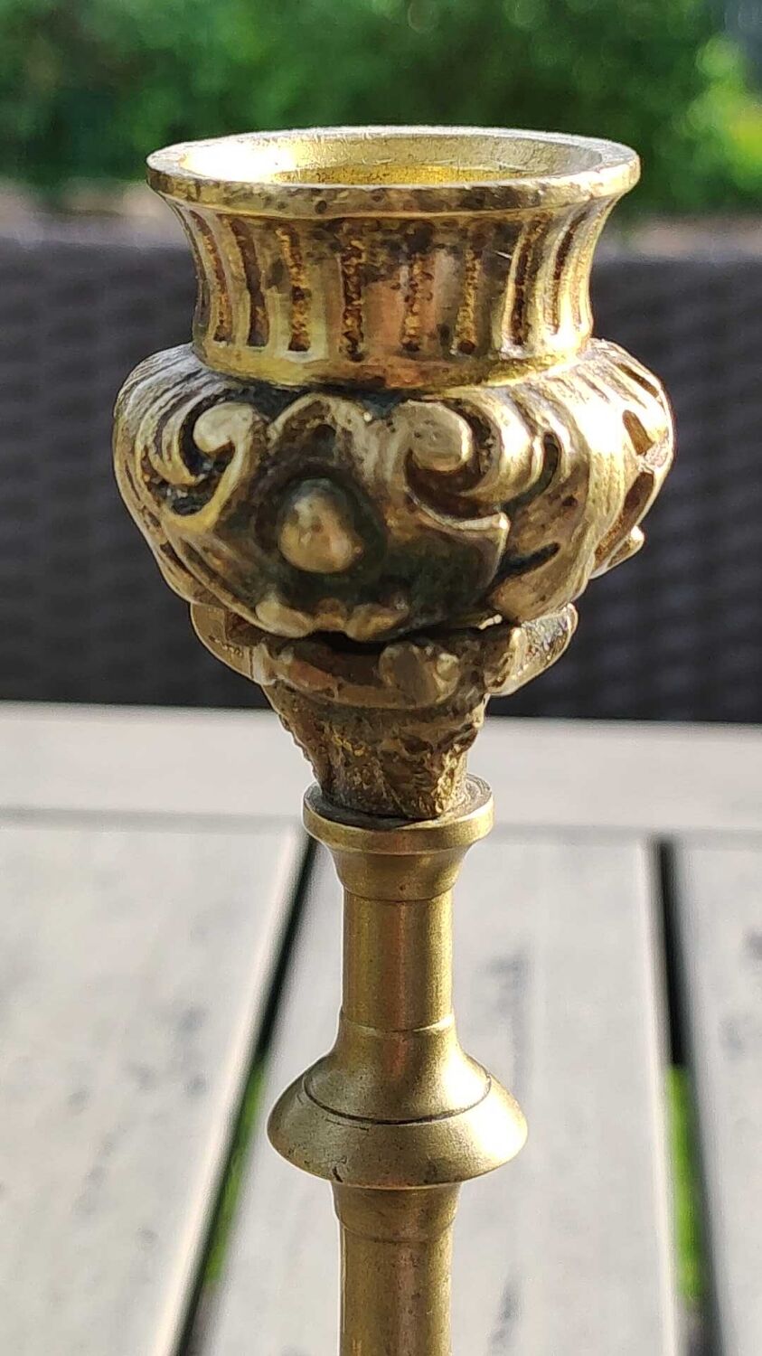Baroque/Antique style torch candleholder, nineteenth, gilded bronze. Head motifs, volute arabesques
