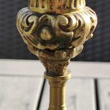 Baroque/Antique style torch candleholder, nineteenth, gilded bronze. Head motifs, volute arabesques