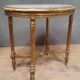 Oval coffee table in gilded wood in the Louis XVI style.