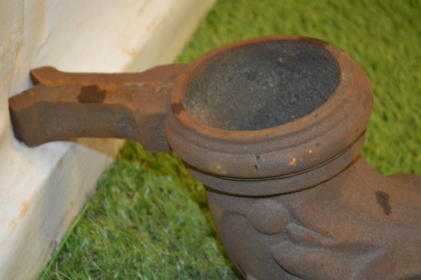 Cast iron gutter downspout in the shape of a dolphin