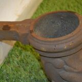 Cast iron gutter downspout in the shape of a dolphin