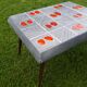Small 1960s enamelled table, spindle legs, signed jd.