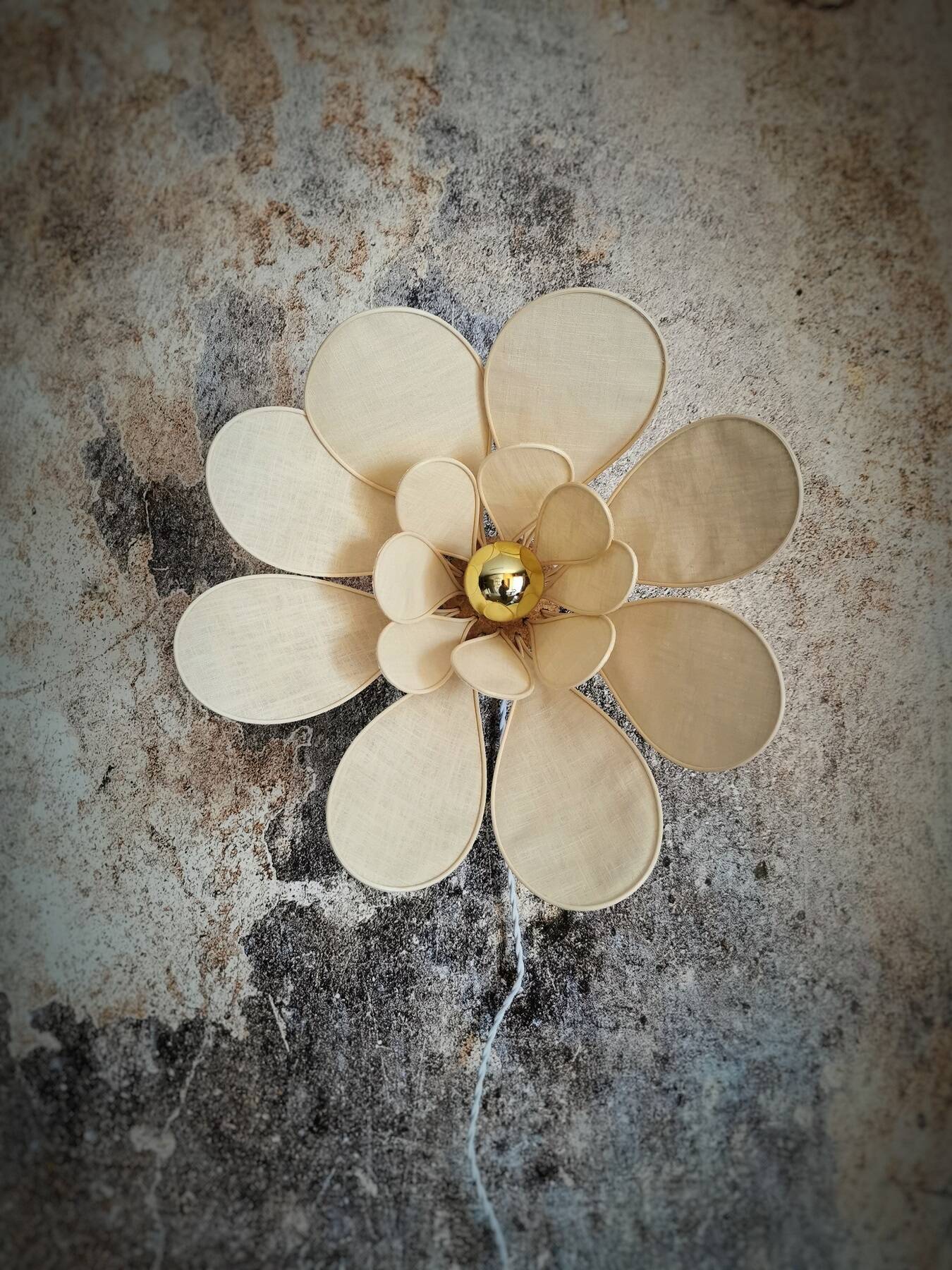 Flower wall light made of rattan and sand linen petals
