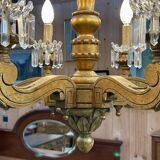 Golden wooden chandelier with crystal pendants from the 19th century.